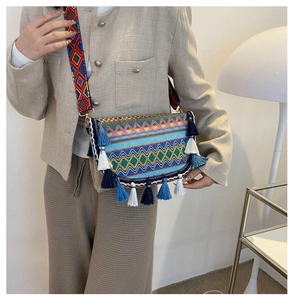 Close-up of Bohemian woven crossbody bag featuring colorful patterns and tassel details