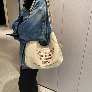 Chic beige canvas hobo bag with brown letter print and adjustable shoulder strap