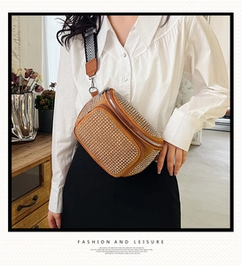 Detailed view of tan bucket bag with sparkling silver rhinestones and woven strap