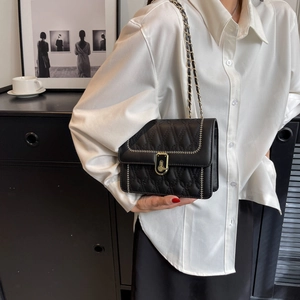 Elegant black quilted chain shoulder bag for women with gold clasp and white stitching