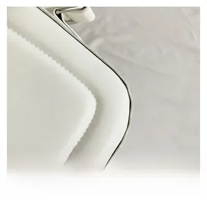 Detailed close-up of premium white leather texture and precise stitching on the handbag