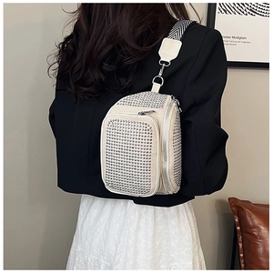 Detail of white studded chest bag with silver rivets and chevron patterned wide strap