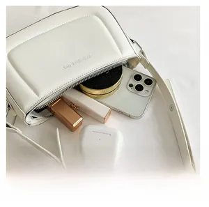 Detail view of the white PU leather shoulder bag showing spacious interior capacity