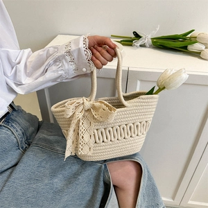 Large cream woven basket bag with lace bow decoration for a summer forest style