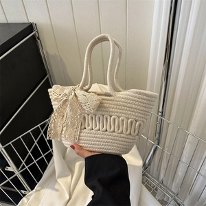 Minimalist beige woven tote bag with lace bow and wave texture for summer fashion
