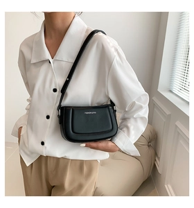 Side view of a black crescent shoulder bag with a fashion logo and leather strap