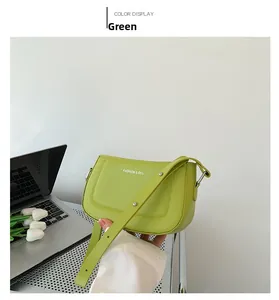 Detail of green leather handbag featuring Fashion & RYX lettering and silver hardware