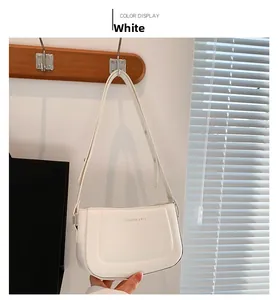 White hobo bag with adjustable strap and Fashion & RYX text logo in a home setting