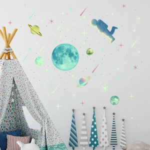 Detailed view of astronaut and moon luminous wall stickers in a cozy nursery bedroom