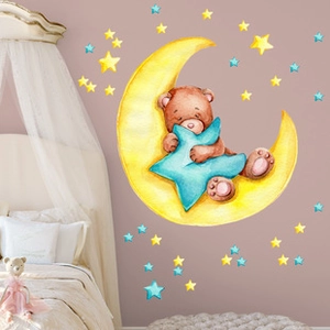 Nursery wall decal featuring a sleeping bear on a moon with stars in watercolor style