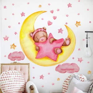 Detail view of panda and moon wall stickers in a cozy nursery room setting