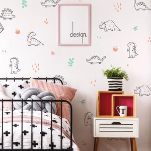 Detailed view of colorful cartoon dinosaur wall decals in a cozy children bedroom decor