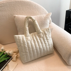 Minimalist cream white quilted down tote bag with vertical stitching for women