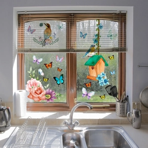 Floral butterfly static window decals on kitchen glass showing birds and birdhouse