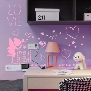 Pink fairy and glowing star wall stickers with LOVE text on light purple bedroom wall