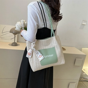 Large straw tote bag with green accents and decorative summer silk scarf handle