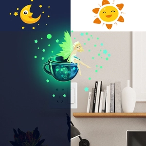 Glow-in-the-dark wall stickers featuring a fairy on a teacup with stars in night and day view