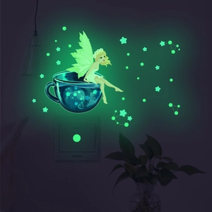 Glow-in-the-dark wall sticker set featuring a fairy and stars on a light switch panel