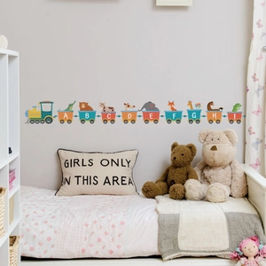 Detail of cartoon animal alphabet train wall stickers in a cozy kids bedroom setting