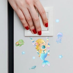 Detailed view of mermaid and sea creature wall stickers applied around a light switch
