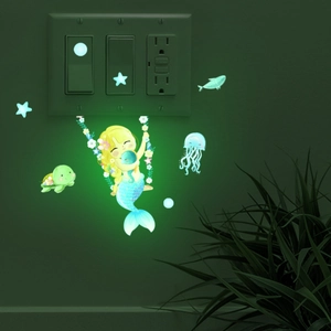 Luminous mermaid and sea creatures wall decals glowing around a light switch in the dark