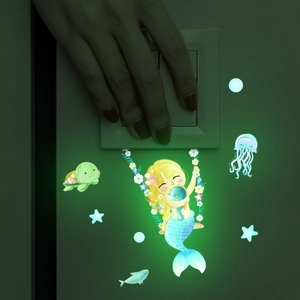Luminous mermaid wall stickers glowing in the dark around light switch and sea creatures