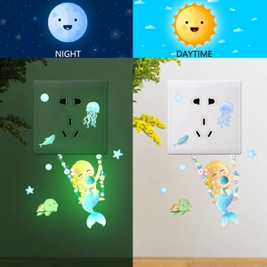 Luminous mermaid wall stickers showing day and night glow effect on light switch