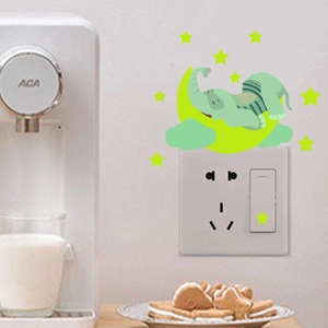 Luminous wall sticker featuring a cartoon elephant sleeping on a moon with glowing stars