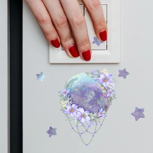 Close-up of luminous mermaid fairy star planet switch sticker on a gray wall