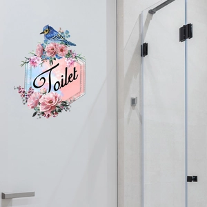 Detailed view of floral bathroom wall decal with blue bird and pink peony on door