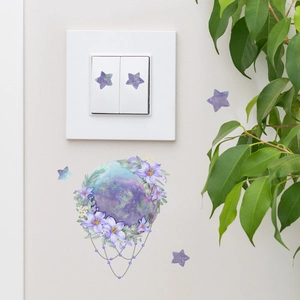 Glow-in-the-dark star and planet wall stickers around light switch in bedroom decor