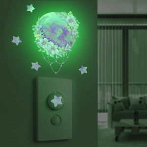 Detailed view of luminous purple moon and star wall stickers glowing in the dark
