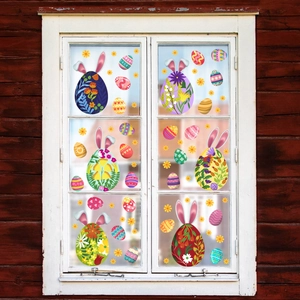 Detailed view of colorful Easter egg and bunny ear window clings on a glass pane