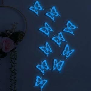 Luminous 3D hollow butterfly wall stickers with bright blue glow in the dark room