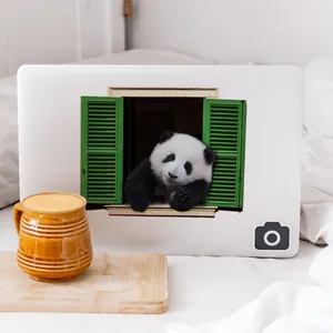 Close-up of 3D giant panda window sticker on a white laptop lid for office decor