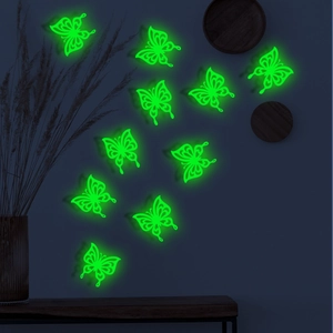 Glow-in-the-dark 3D hollow butterfly wall stickers emitting bright green light in the dark