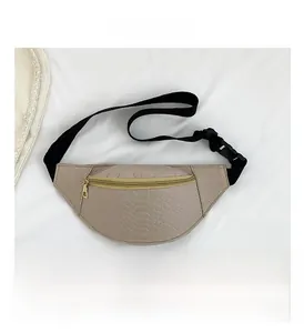 Detail of light beige faux crocodile texture chest bag with gold metal zipper and strap