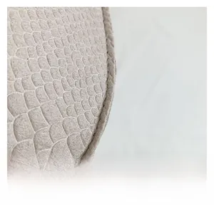 Macro shot of grey embossed snake texture fabric with neat stitching on a chic bag
