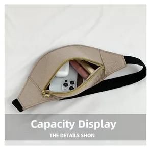 Internal capacity view of textured beige waist bag showing phone and cosmetics