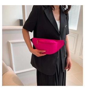 Detail of hot pink animal embossed fanny pack with black adjustable nylon strap on model