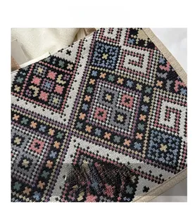 Close-up of geometric woven canvas tote with colorful ethnic patterns and hemp texture