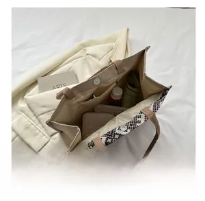 Internal view of beige quilted tote bag showing large capacity and zipper pocket