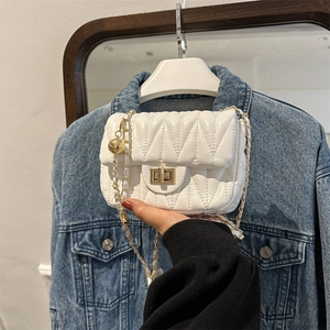 Quilted white crossbody bag with gold chain strap and decorative sphere charm