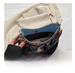 Interior view showing the capacity of a bohemian woven bag with colorful tassels