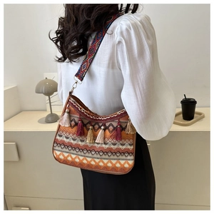 Detailed back view of a bohemian crossbody bag with colorful tassels and ethnic patterns