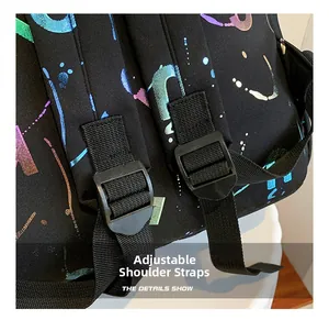 Detail showing adjustable woven straps with plastic buckles on a black graffiti backpack