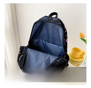 Detail view of the printed backpack interior with blue lining and storage compartments