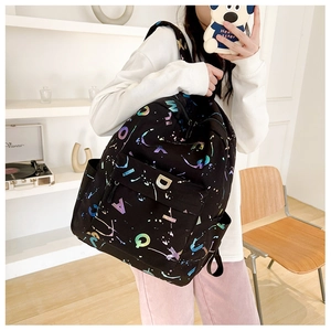 Close-up of black backpack featuring colorful alphabet prints and starry galaxy patterns