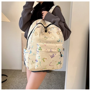 Detail of cream backpack with colorful letter print and splashes for students