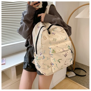Detail of cream backpack with colorful letters and graffiti print for school travel